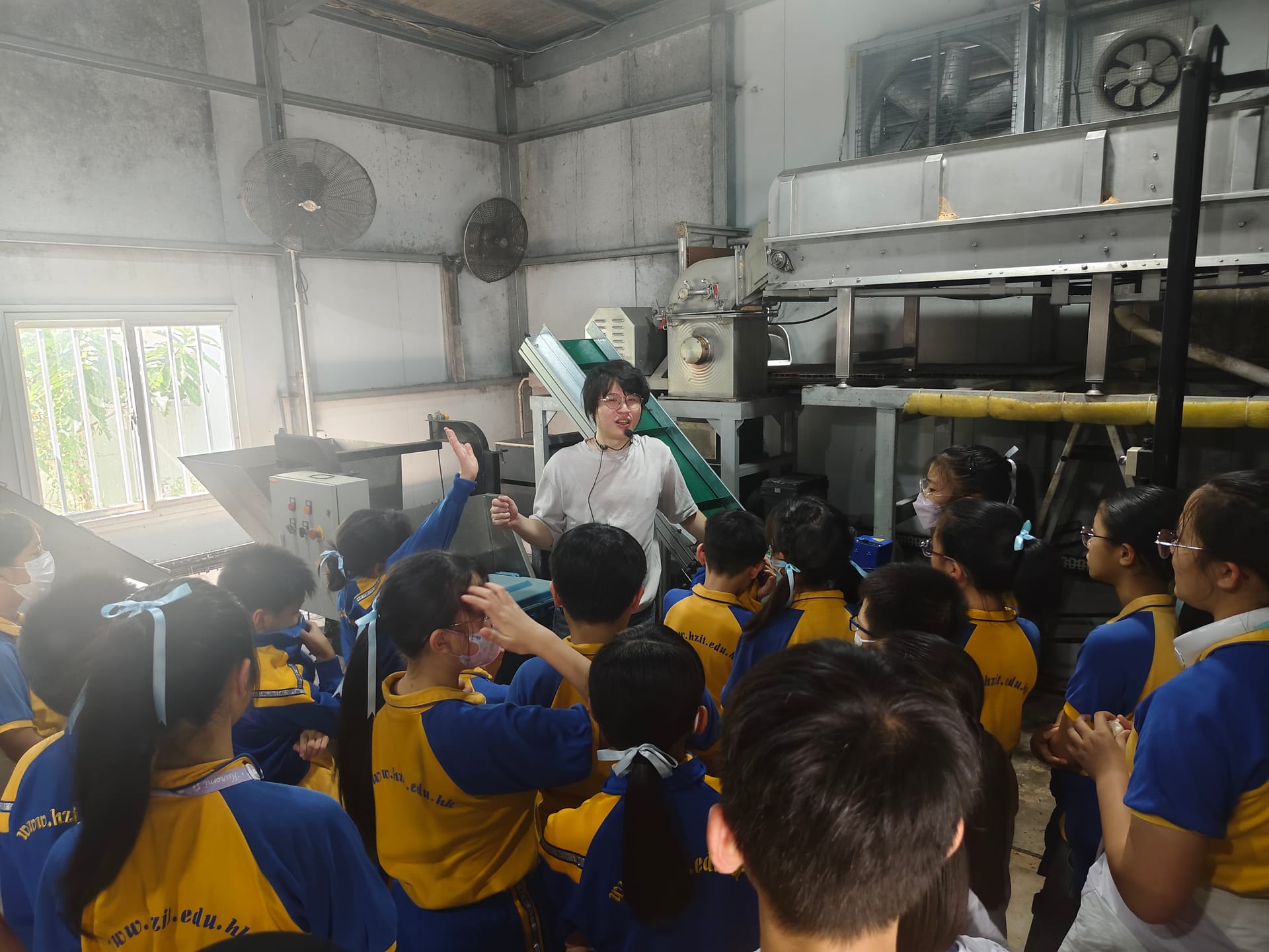Tour Guide introducing food waste processing machinery